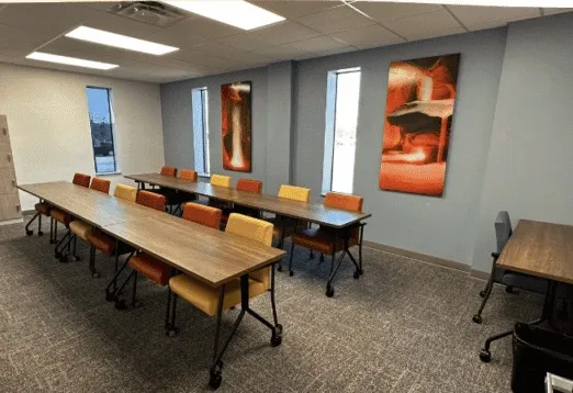 A group room with long tables and chairs