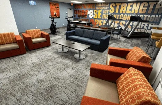 A lounge with armchairs, a sofa and exercise equipment
